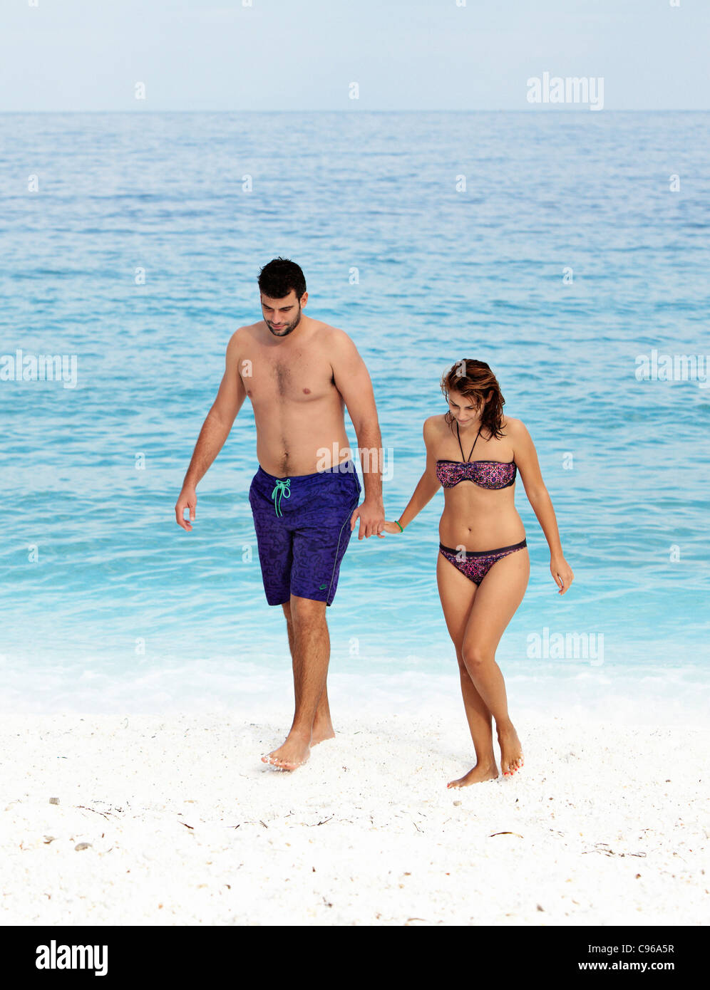 Couple walking on Marble Beach in Thassos island, Greece. Stock Photo
