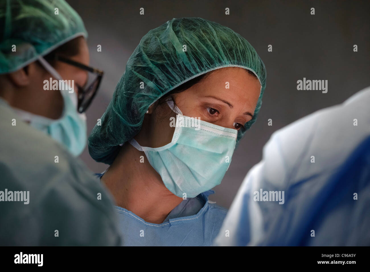 Healthcare professional wearing surgical face mask during surgery Stock