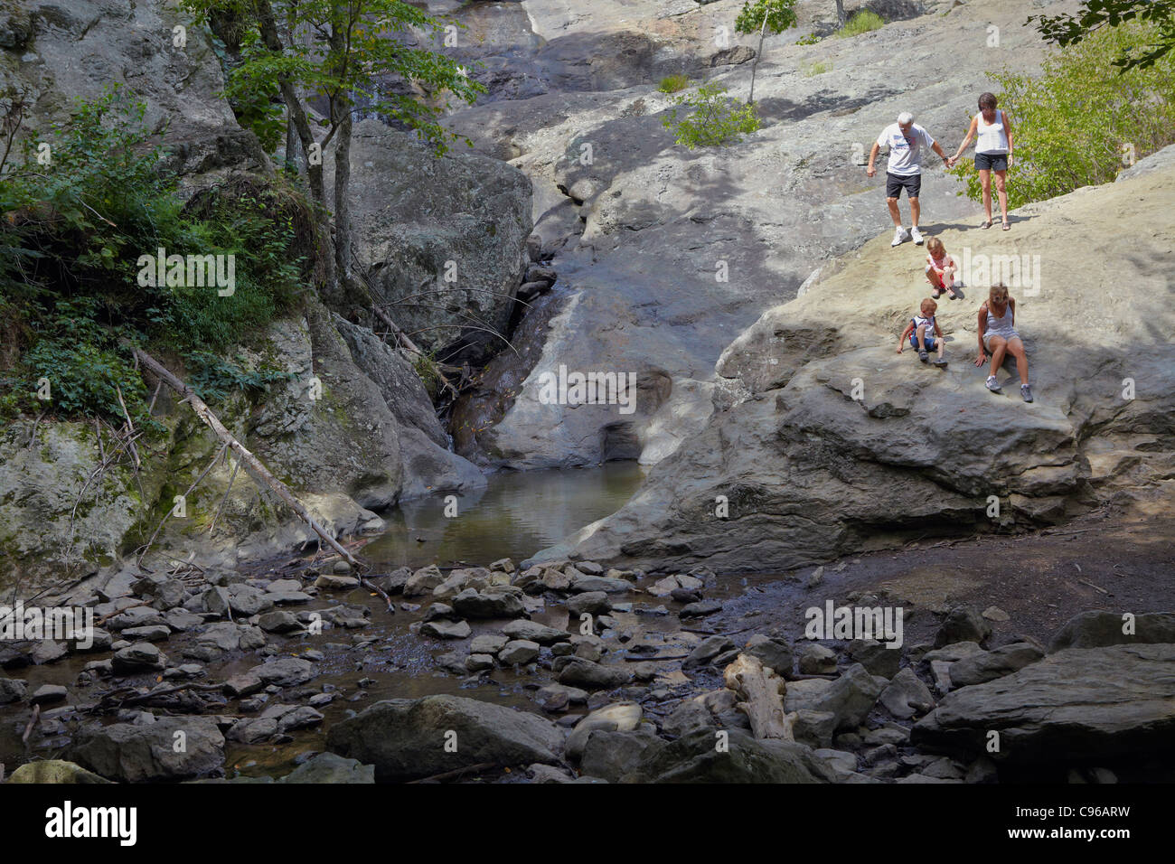 Park visitors climbing down the rock face of Cunningham Falls (during low flow drought ...