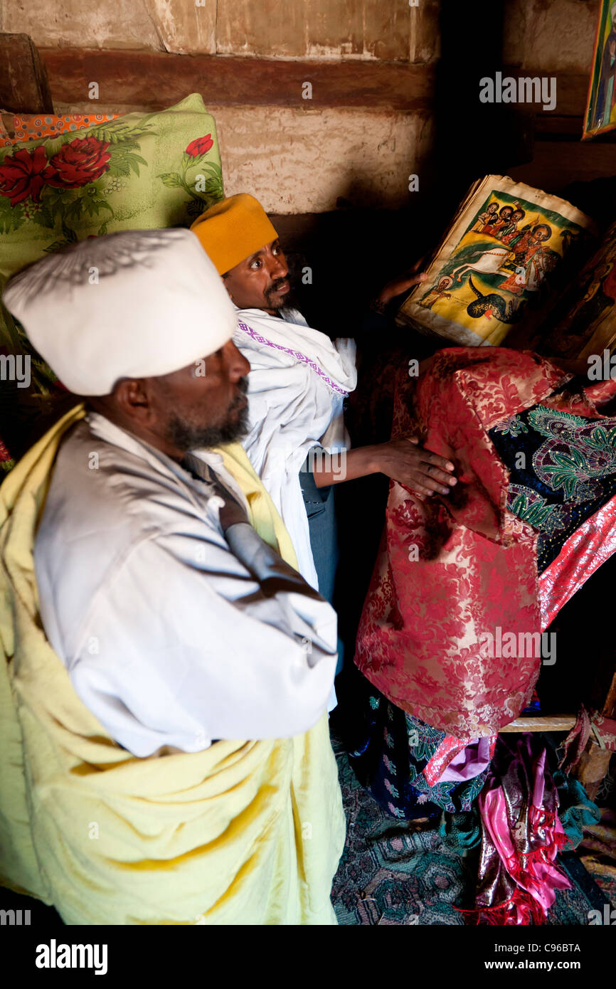 Orthodox Christian priests displaying an illuminated manuscript inside Abuna Aregawi Church at Debre Damo in Tigray, Ethiopia. Stock Photo