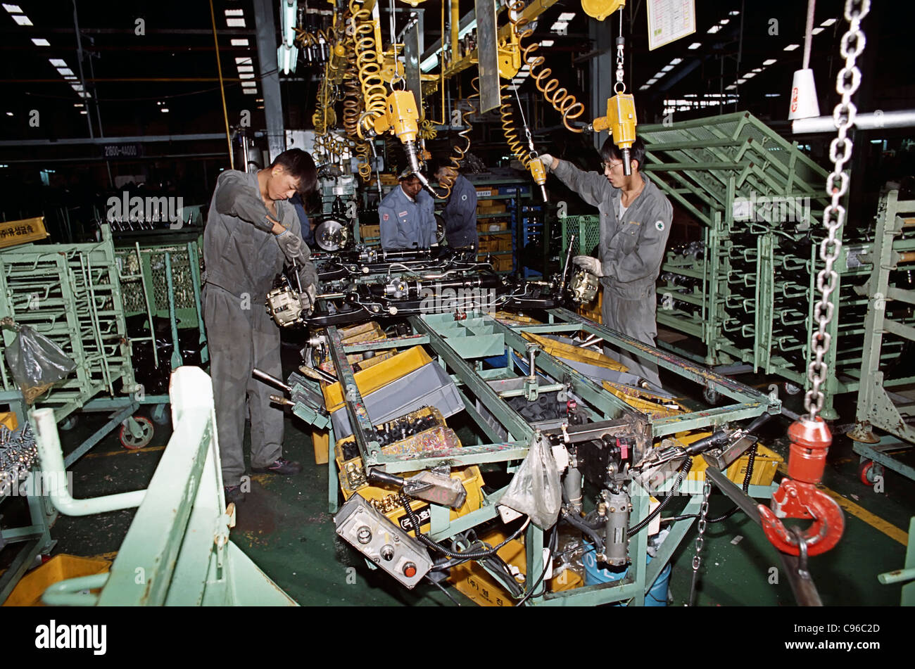 Men working at assembling line in Hyundai car chassis factory in Seoul