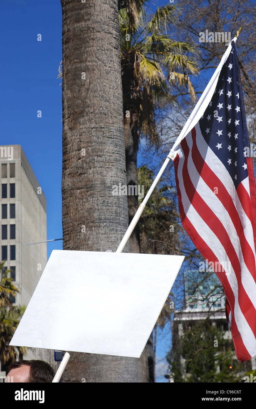 Protester holding sign with copyspace and American flag Stock Photo