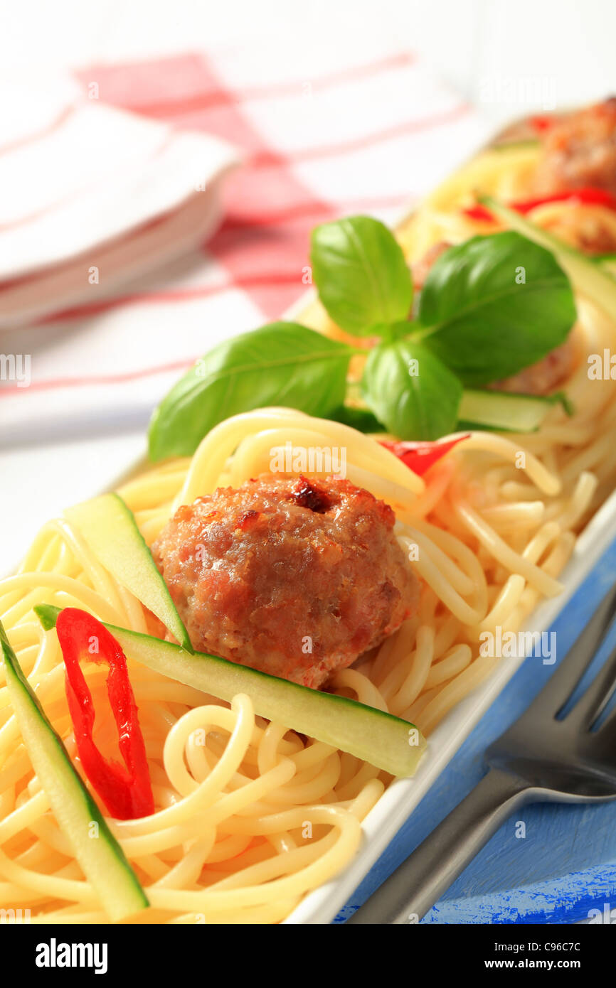 Meatballs on a bed of cooked spaghetti Stock Photo