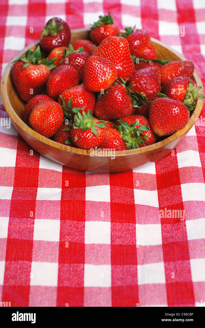 Wooden bowl full of fresh strawberries on a picnic table Stock Photo ...