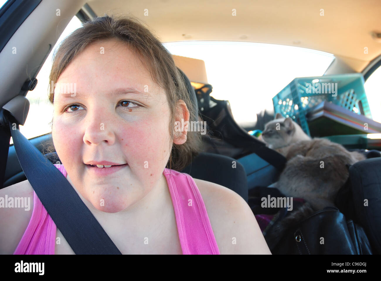 Young visually impaired woman riding in car with her cat Stock Photo