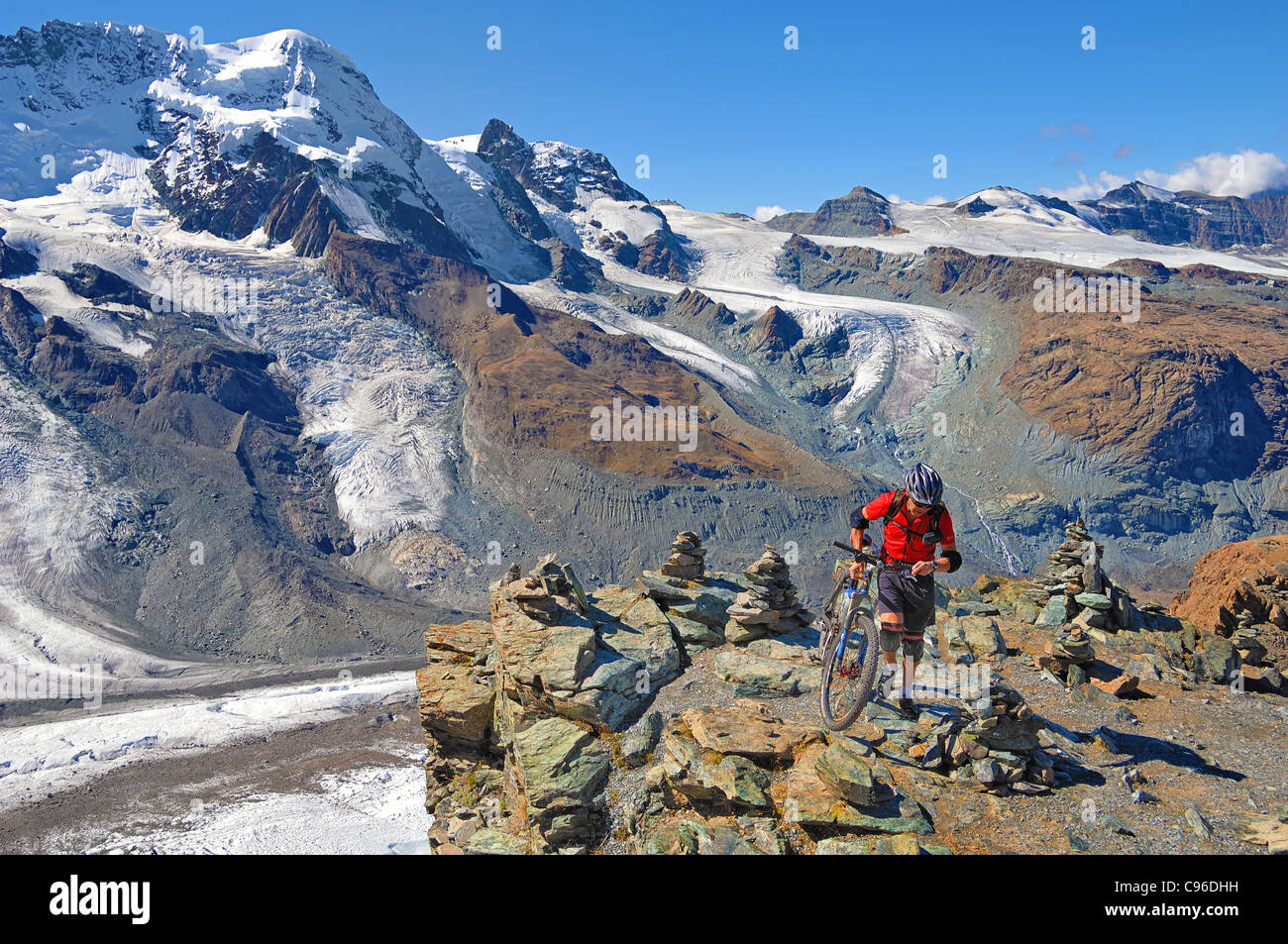 Mountain biker setting off from Rotenboden, 2,815m, down to Zermatt, in Swizerland. Stock Photo