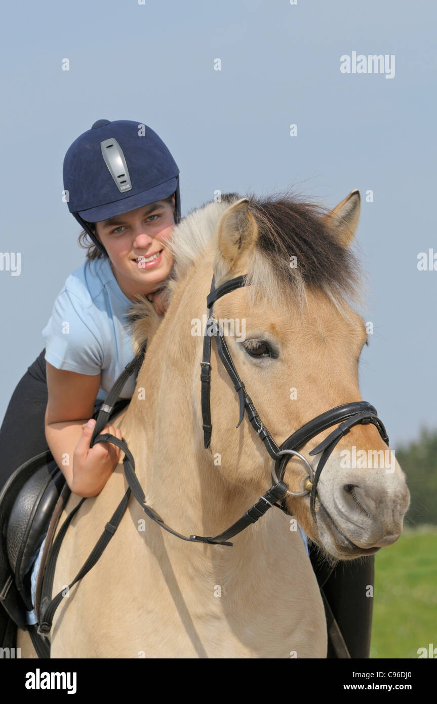 Girl on back of a Norwegian horse Stock Photo