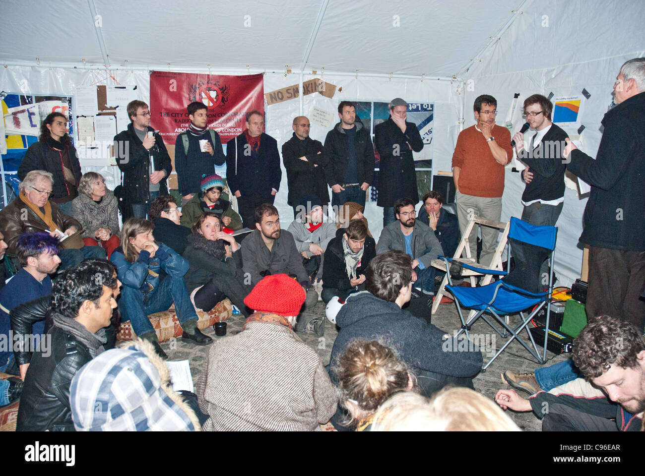George Monbiot (brown sweater) and protesters at the Tent City University, St Pauls discussing the City of London Corporation Stock Photo