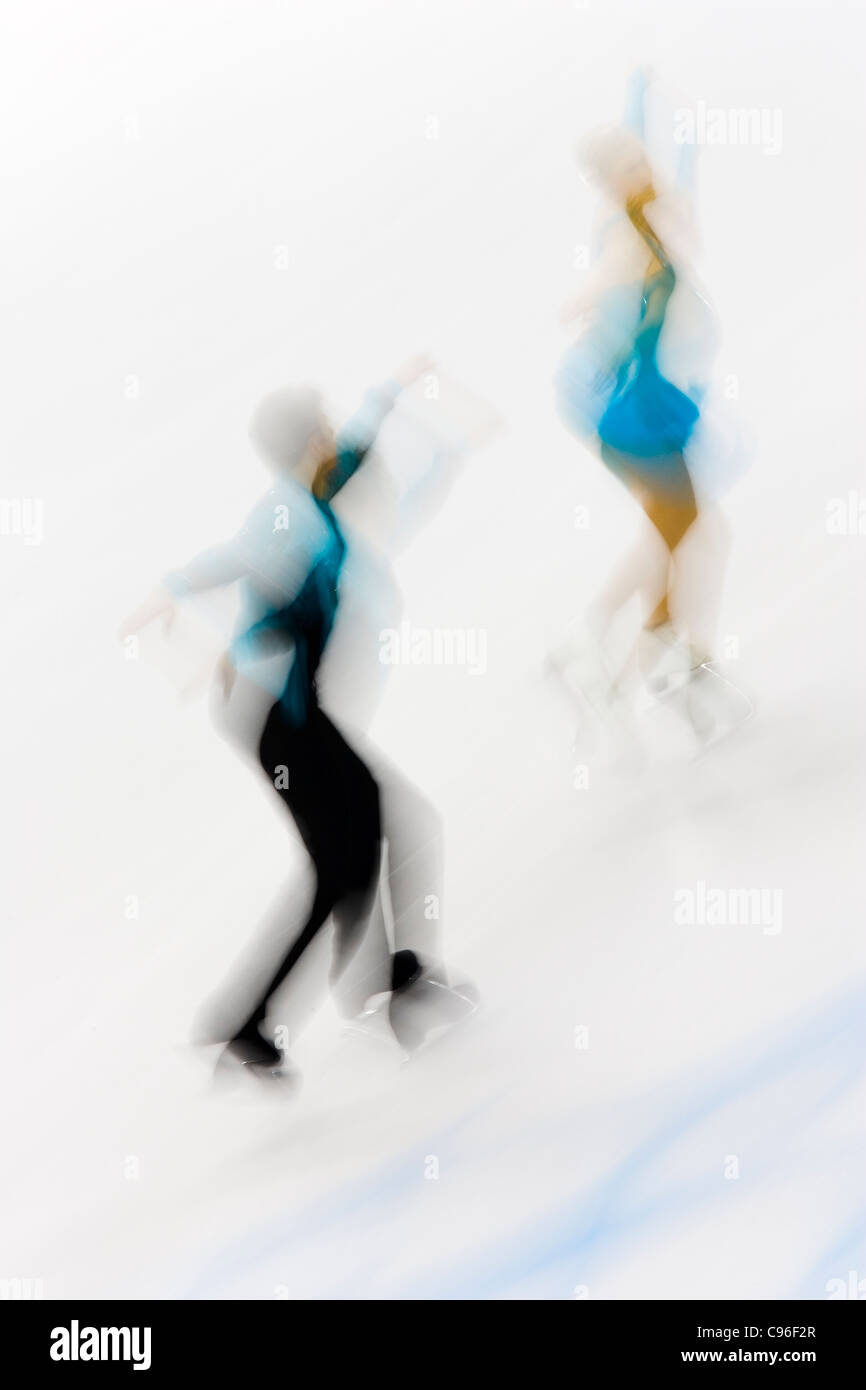 Blurred action of pairs figure skaters. Stock Photo
