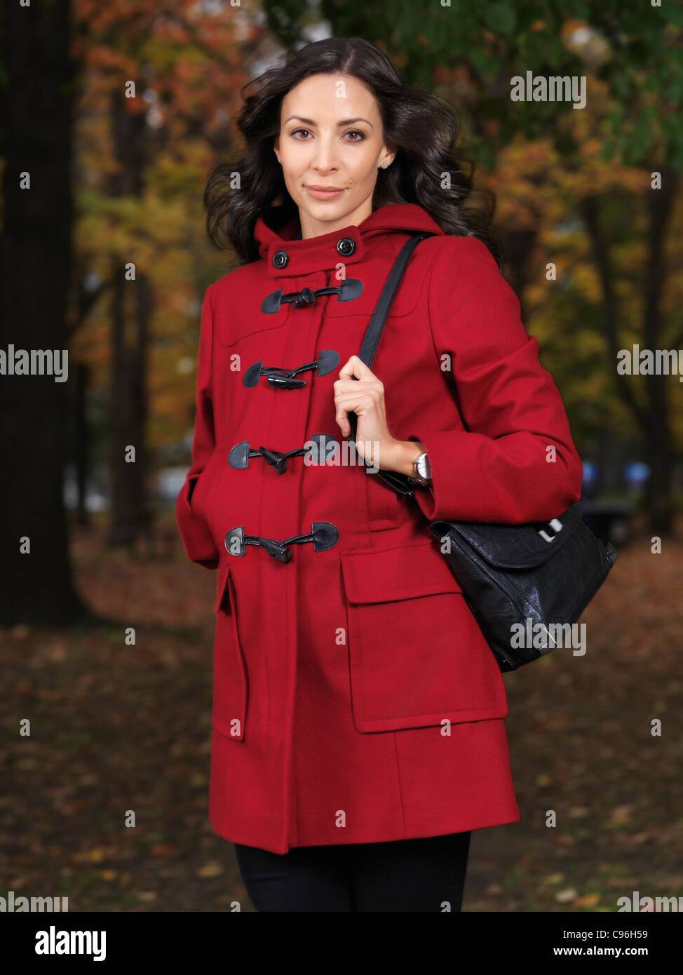 Woman wearing a red coat in fall Stock Photo