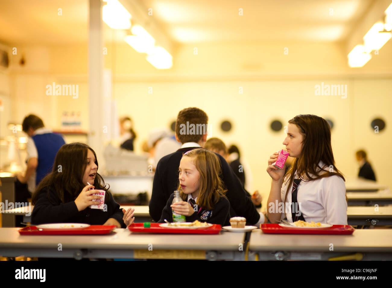 Secondary school children in the canteen having lunch, Wales UK Stock Photo