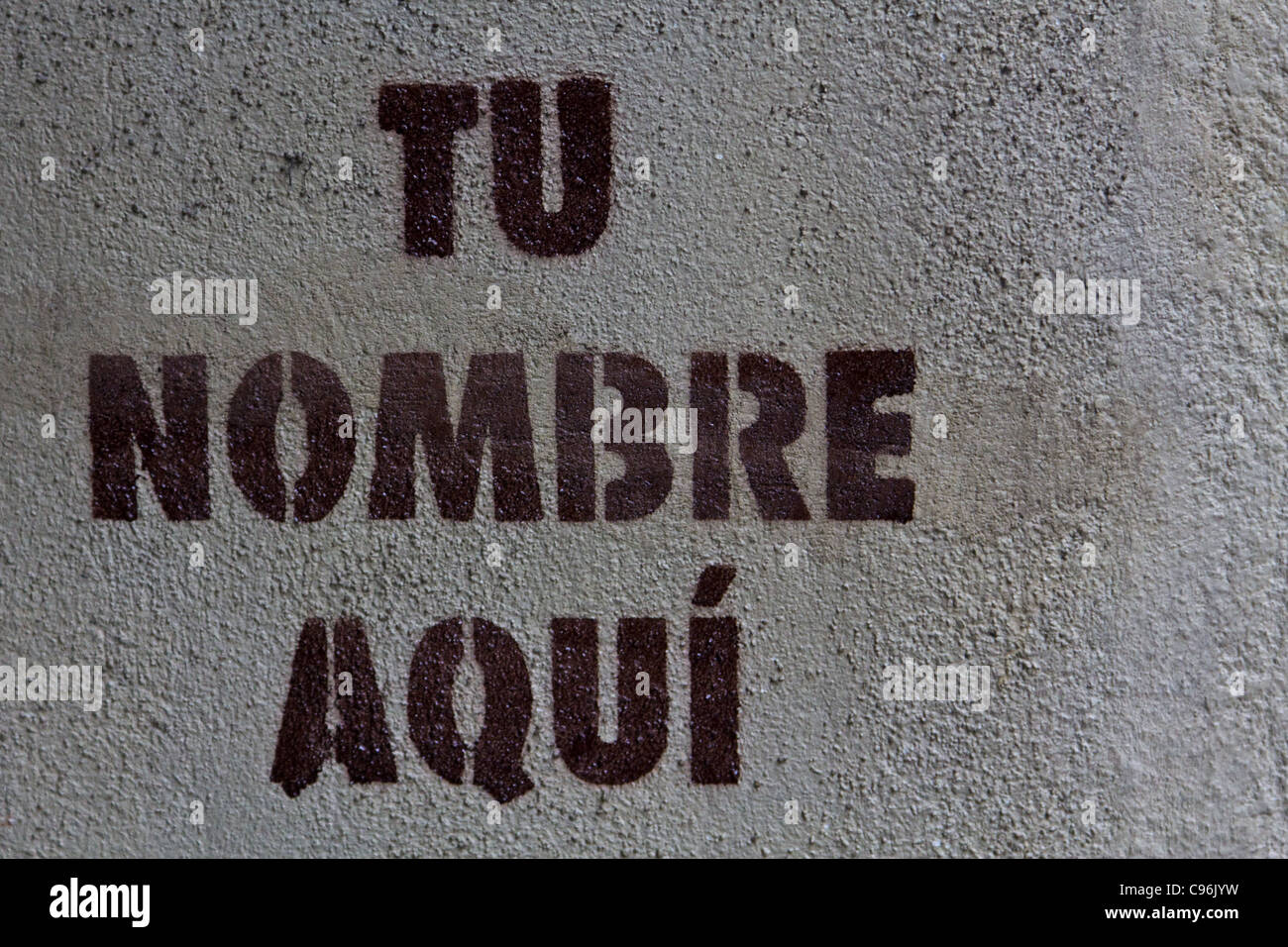 A stencil print on a public space in Madrid indicating "your name here