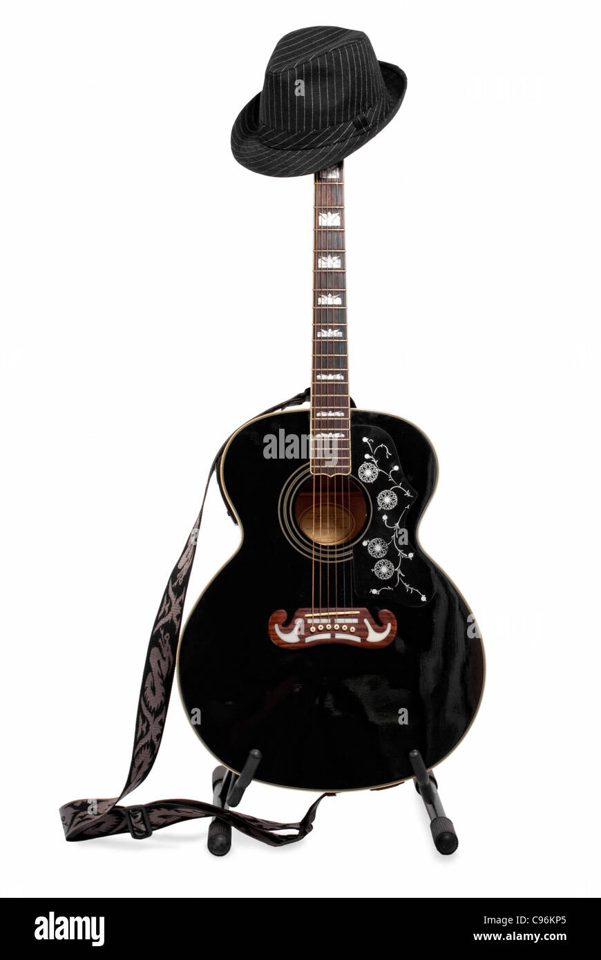 Guitar with hat on a stand. All kinds of musical instruments in ...