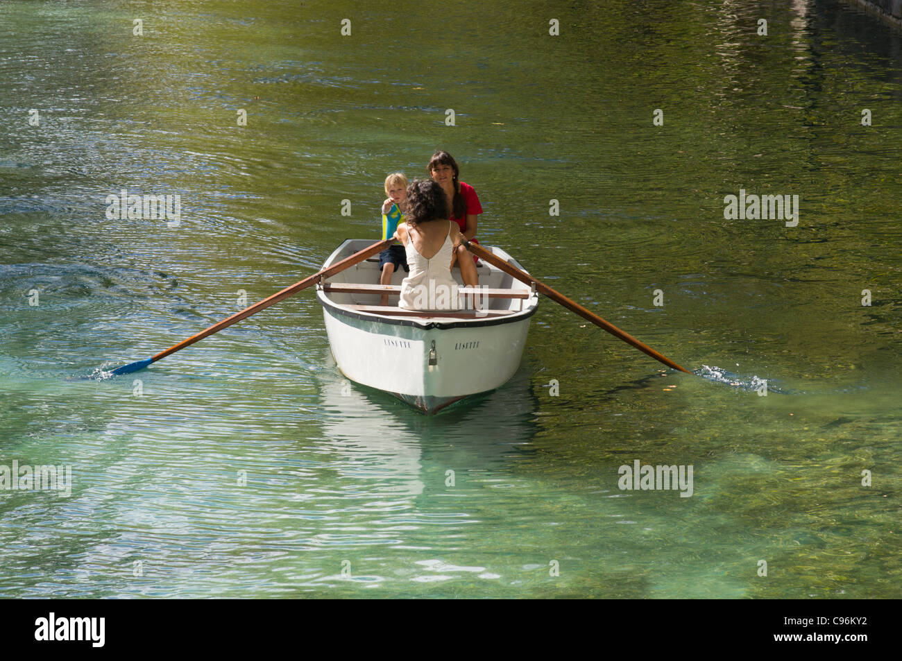 Two young French women in a rowing boat with a small boy Stock Photo Alamy