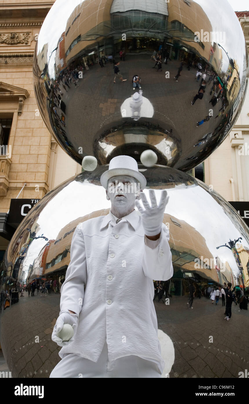 A street performer in front the Rundle Mall Spheres.  Adelaide, South Australia, Australia Stock Photo