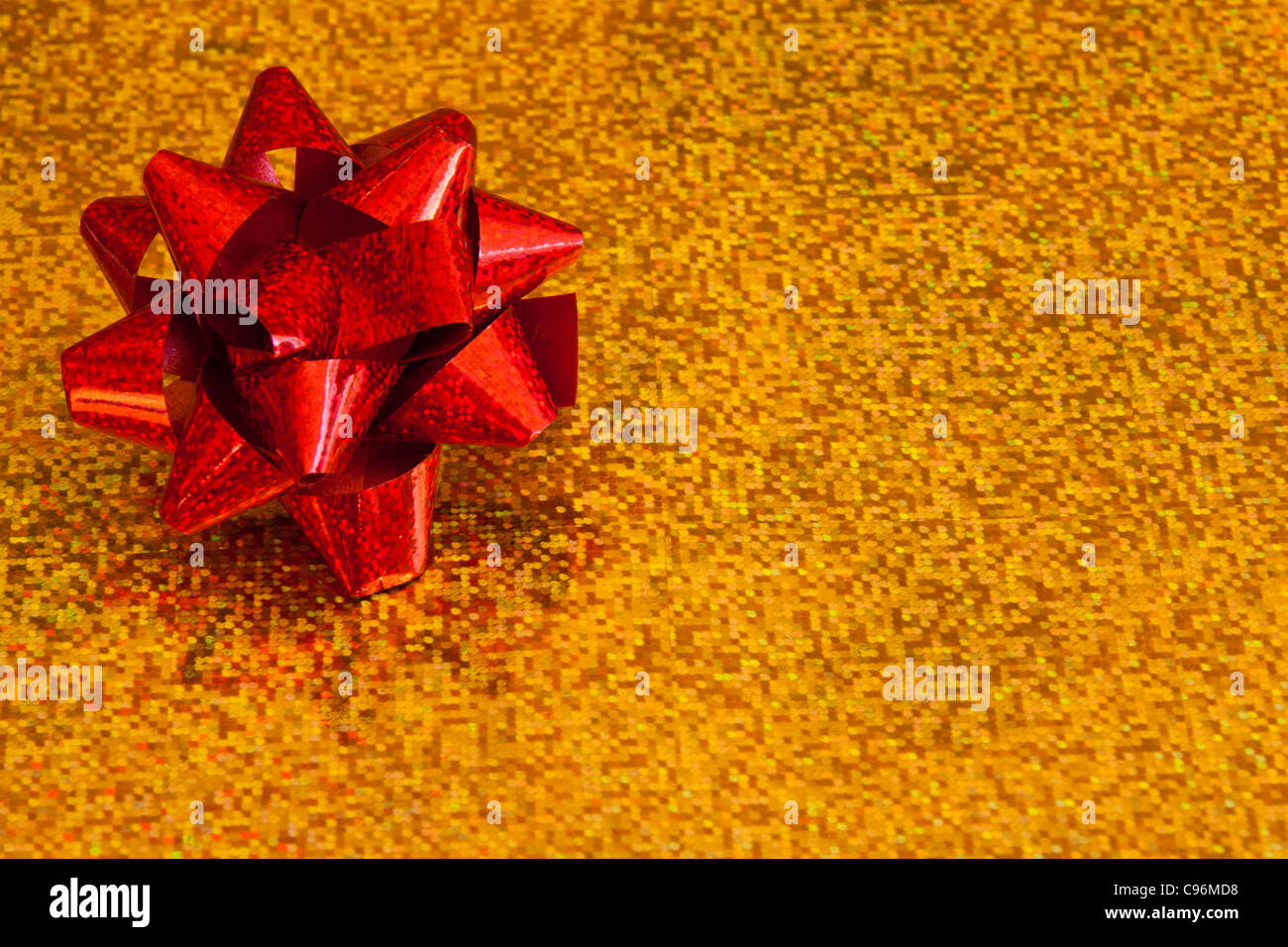 A red bow on a gold background Stock Photo