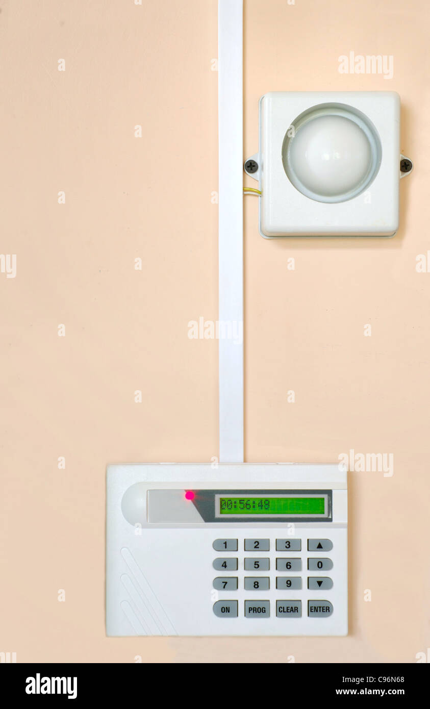 programing home security fire alarm on the wall Stock Photo