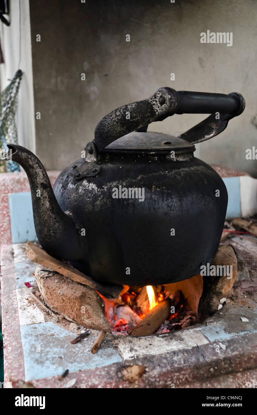 Black sooty old kettle on wood fire Stock Photo Alamy