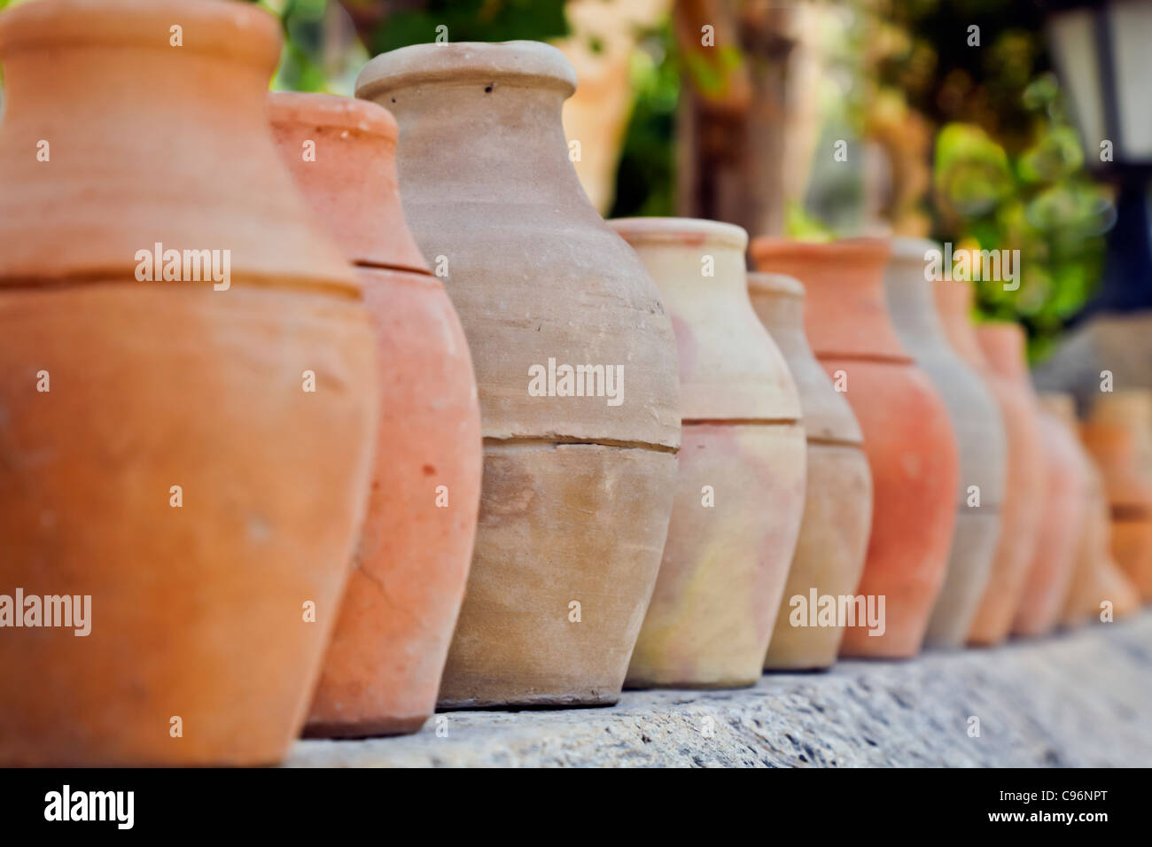 Landscape, Goreme Turkey, Garden decorative feature of earthen clay pots and vessels lined on a garden wall Stock Photo