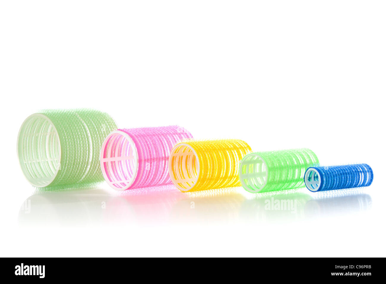 Multicolored hair curlers isolated over white background Stock Photo