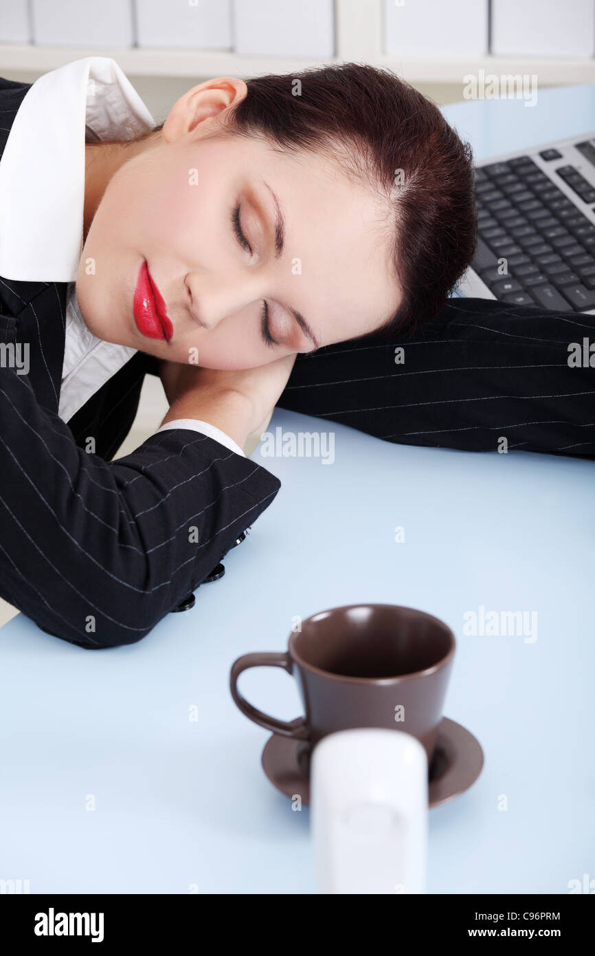 Beauty caucasian businesswoman sleeping on the desk in the office Stock ...