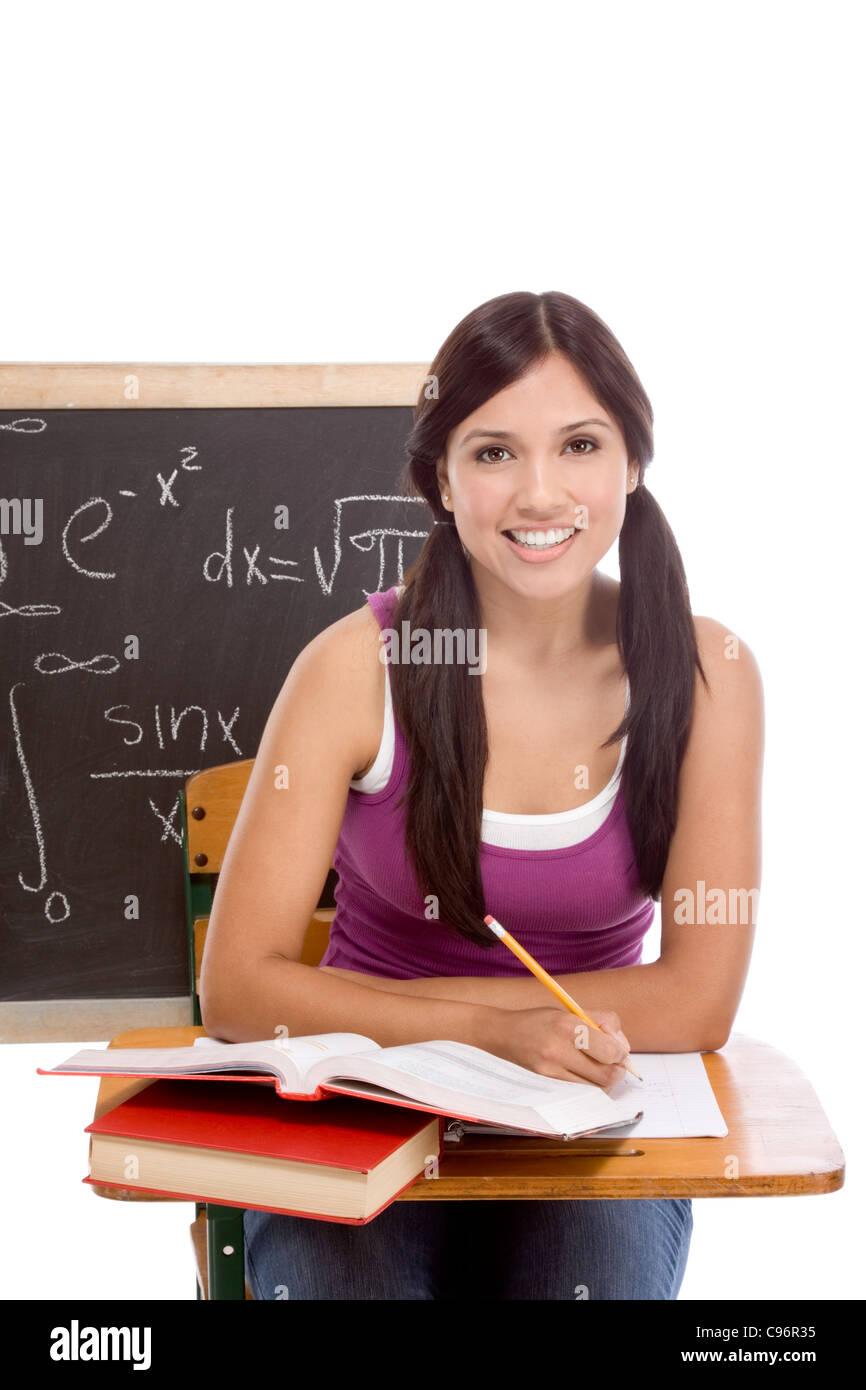 High school or college student by the desk at math class Blackboard with advanced mathematical formulas is visible in background Stock Photo