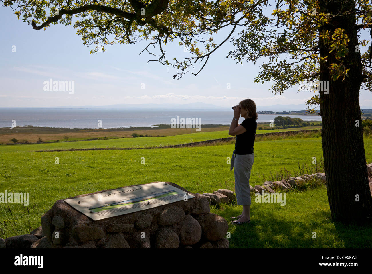 Woman viewing the Solway Firth from Drumburn Point, Dumfries & Galloway Stock Photo