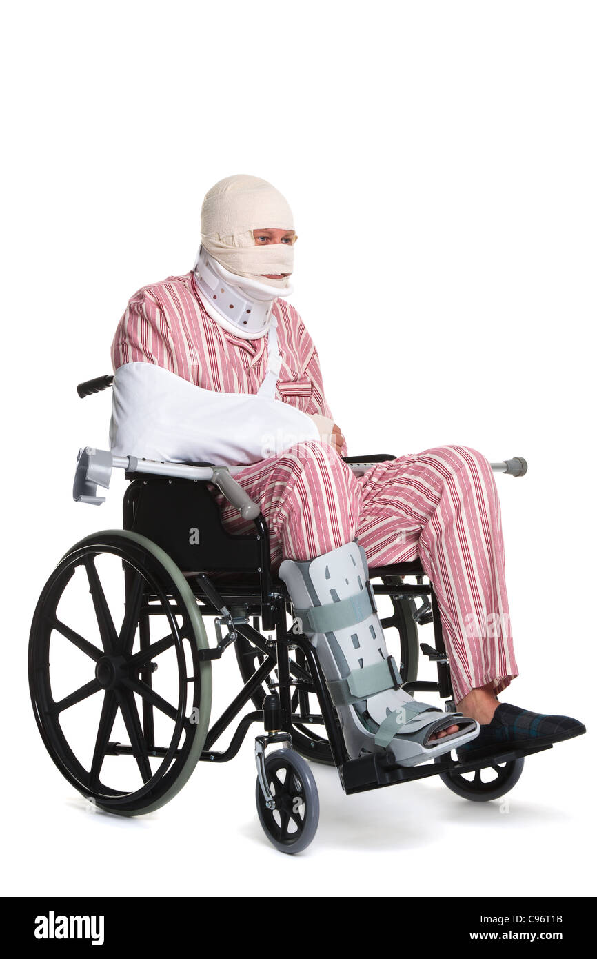 Photo of a man with various injuries wearing striped pyjames and sitting in a wheelchair. Stock Photo
