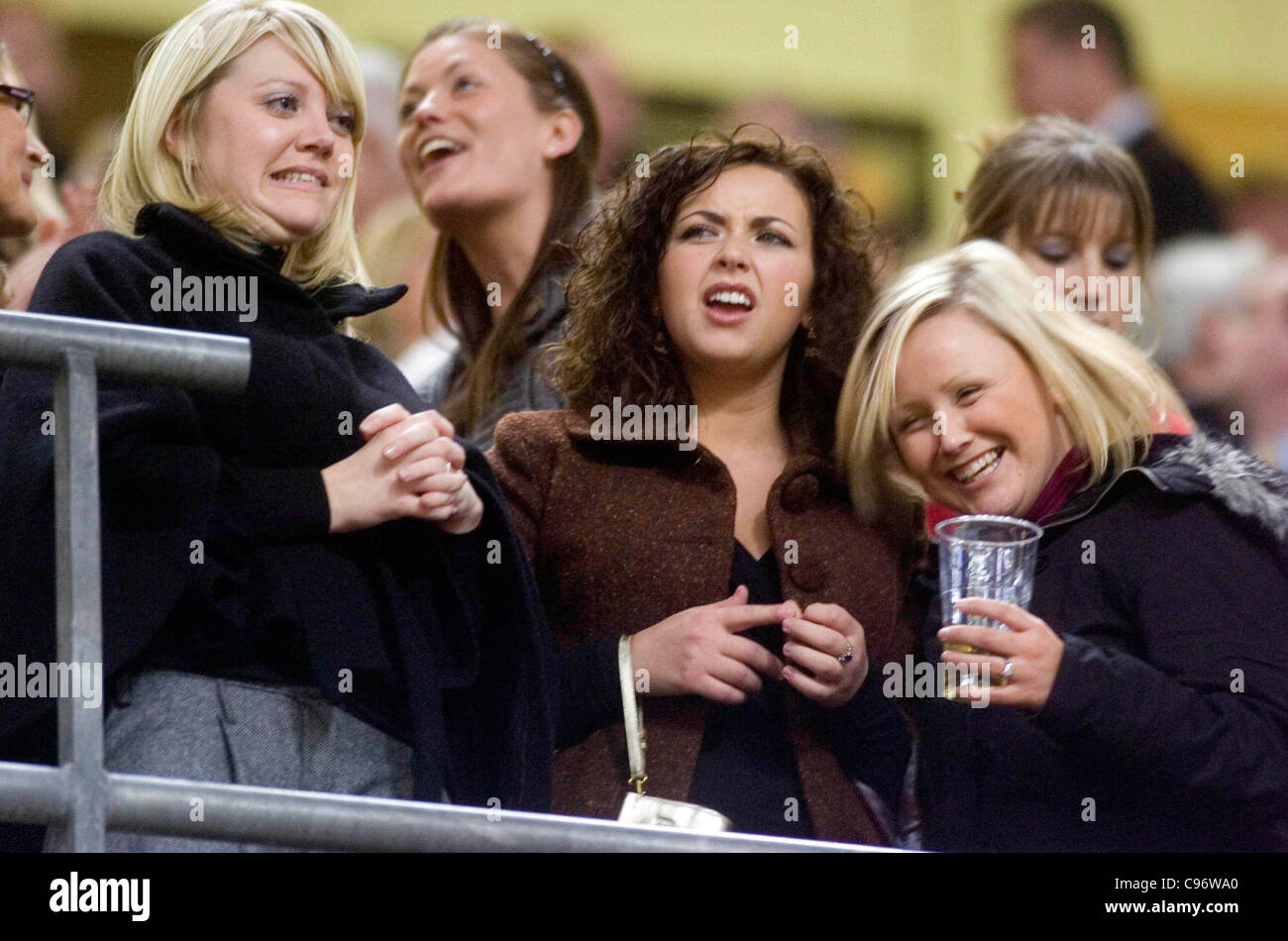 Charlotte church shares her lager drink with her friends during the Wales v Canada rugby international at the Millennium Stadium Stock Photo