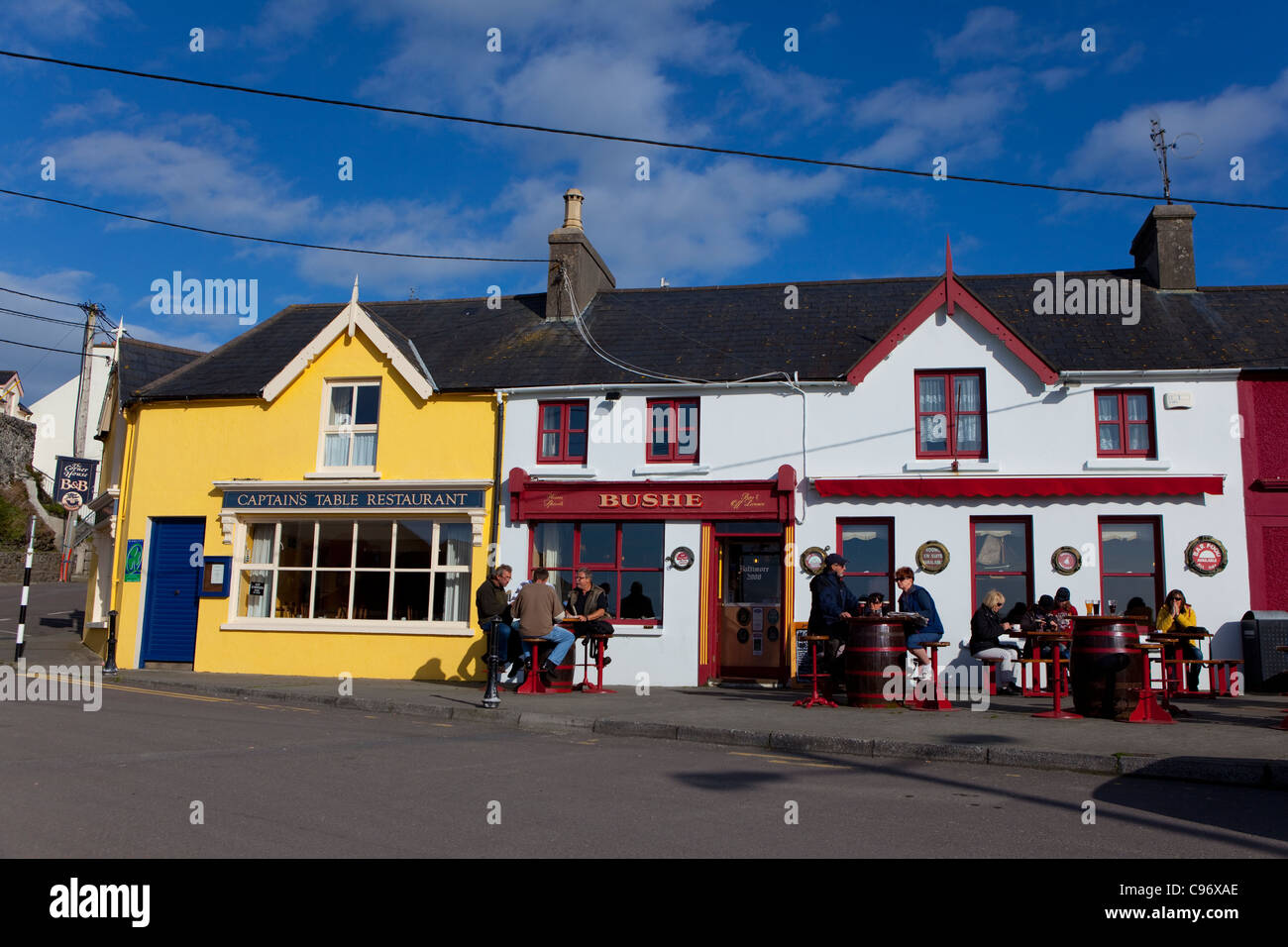 People outside Bushe's Bar in The fishing village of Baltimore, West Cork, Ireland Stock Photo
