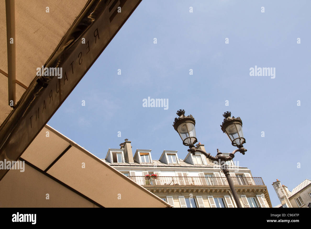 Cafe awning and Paris apartment building Stock Photo