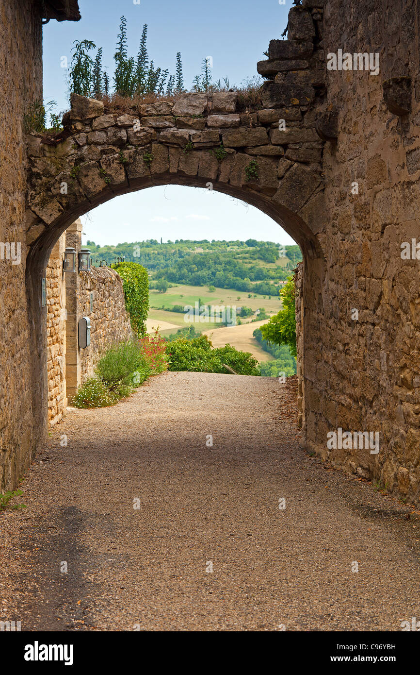 Archway across narrow street of the medieval village of Saint-Robert with valley view. Stock Photo