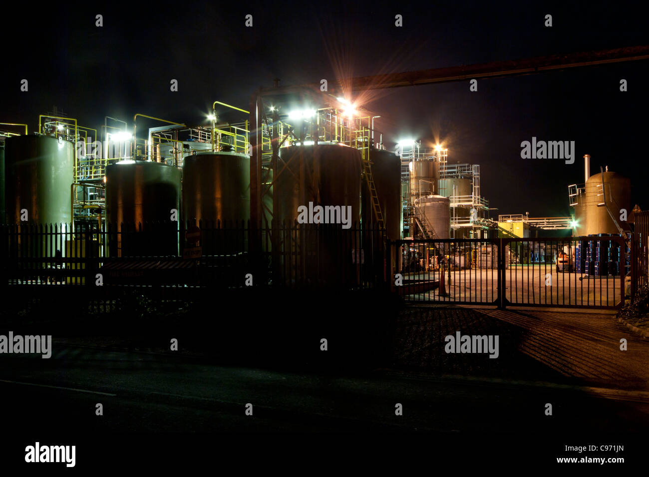 Industrial Building Buildings Plant Lit Illuminated At Night after dark Stock Photo