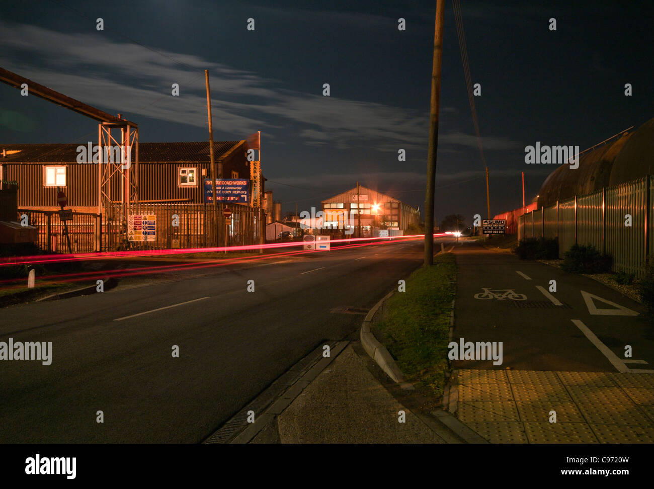 Traffic trails Rye Harbour Road Industrial Area At after dark on a moonlit night time East Sussex UK Stock Photo