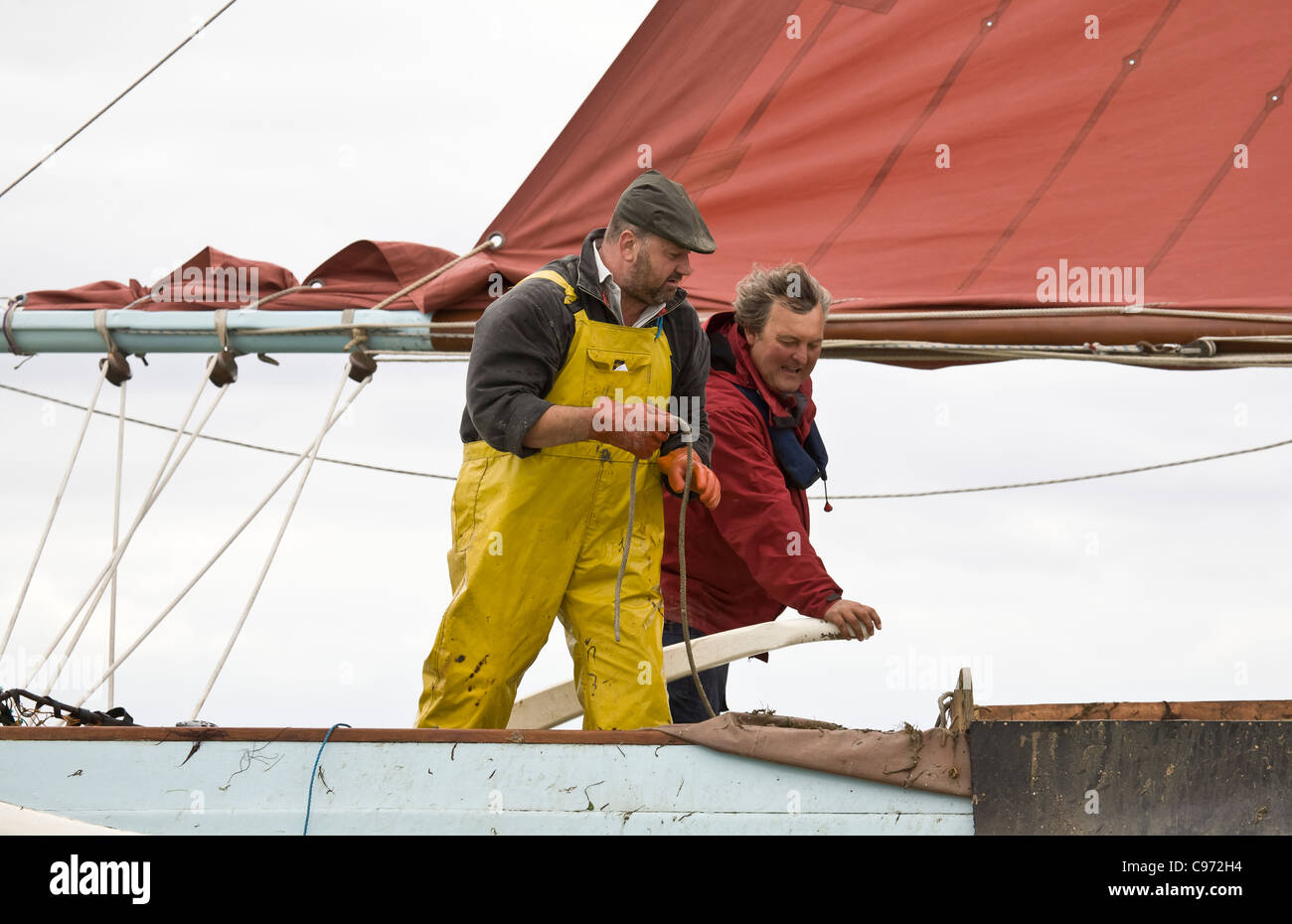 UK TV presenter aboard oyster smack Stock Photo