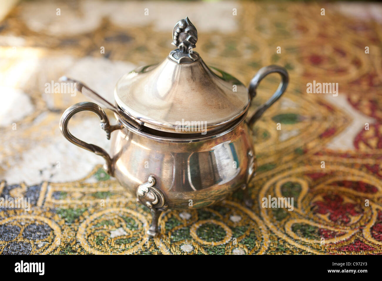 Old silver sugar bowl and spoon Stock Photo