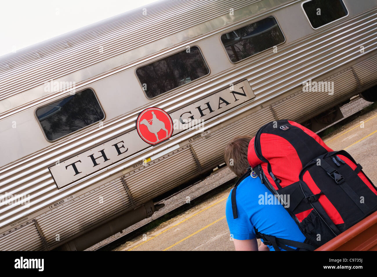 A backpacker waits to board The Ghan train at Alice Springs station