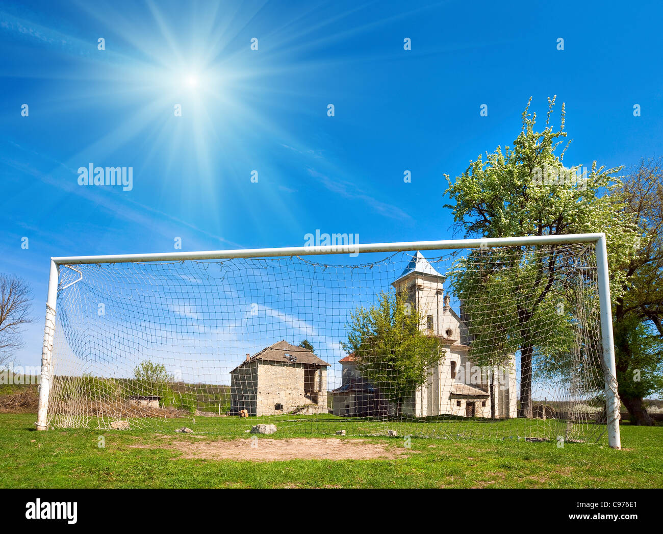 Church of Annunciation of Blessed Virgin Mary (Sydoriv village, Ternopil region, Ukraine, Built in 1726-1730) and football goal. Stock Photo