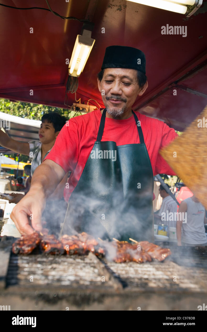Man cooking satay at one of the many foodstalls in the Mindil Beach