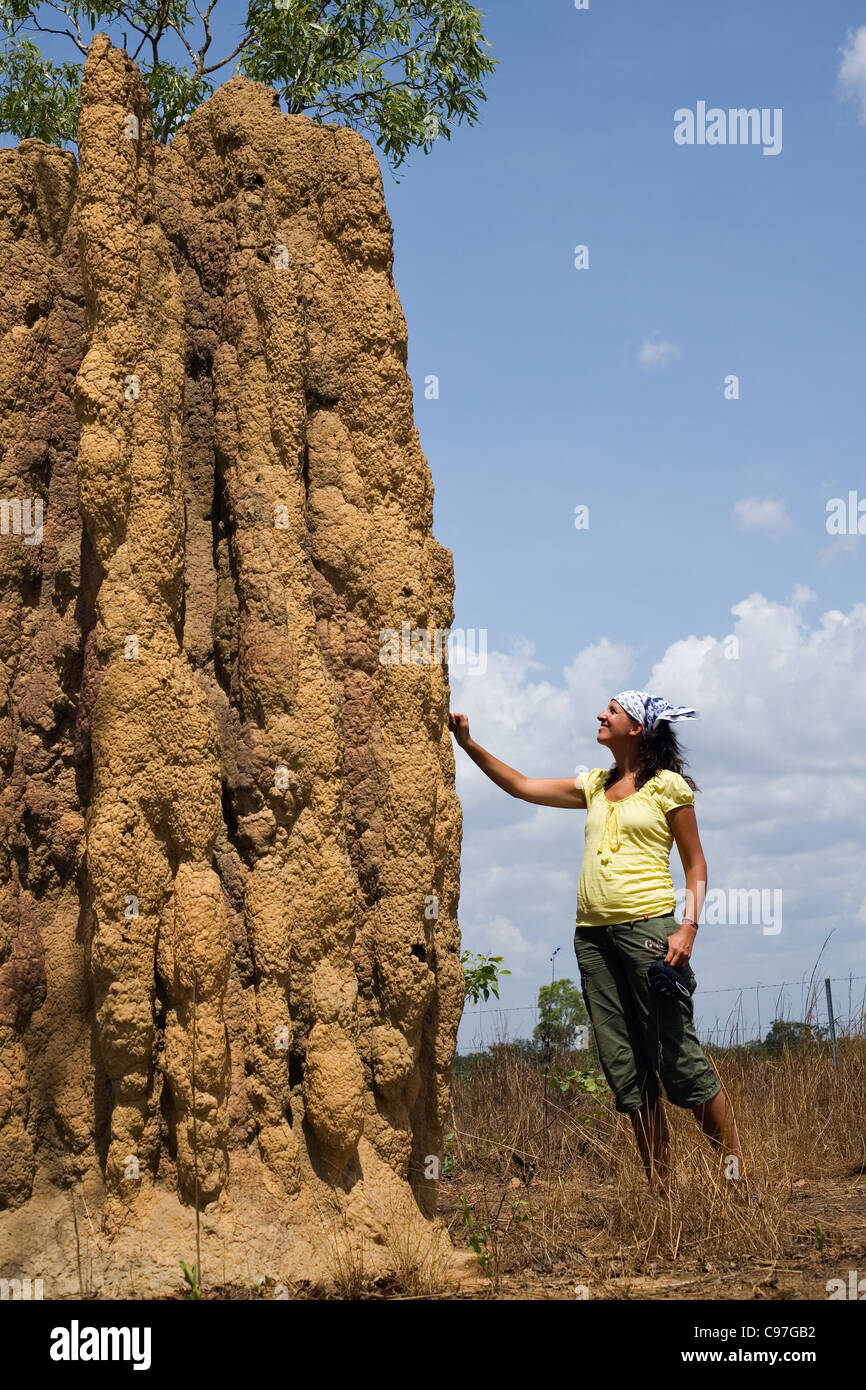 Tourist standing next to cathedral termite mound in Kakadu National Park, Northern Territory, Australia Stock Photo
