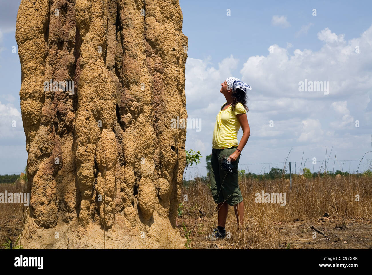 Woman standing next to a cathedral termite mound in Kakadu National Park, Northern Territory, Australia Stock Photo