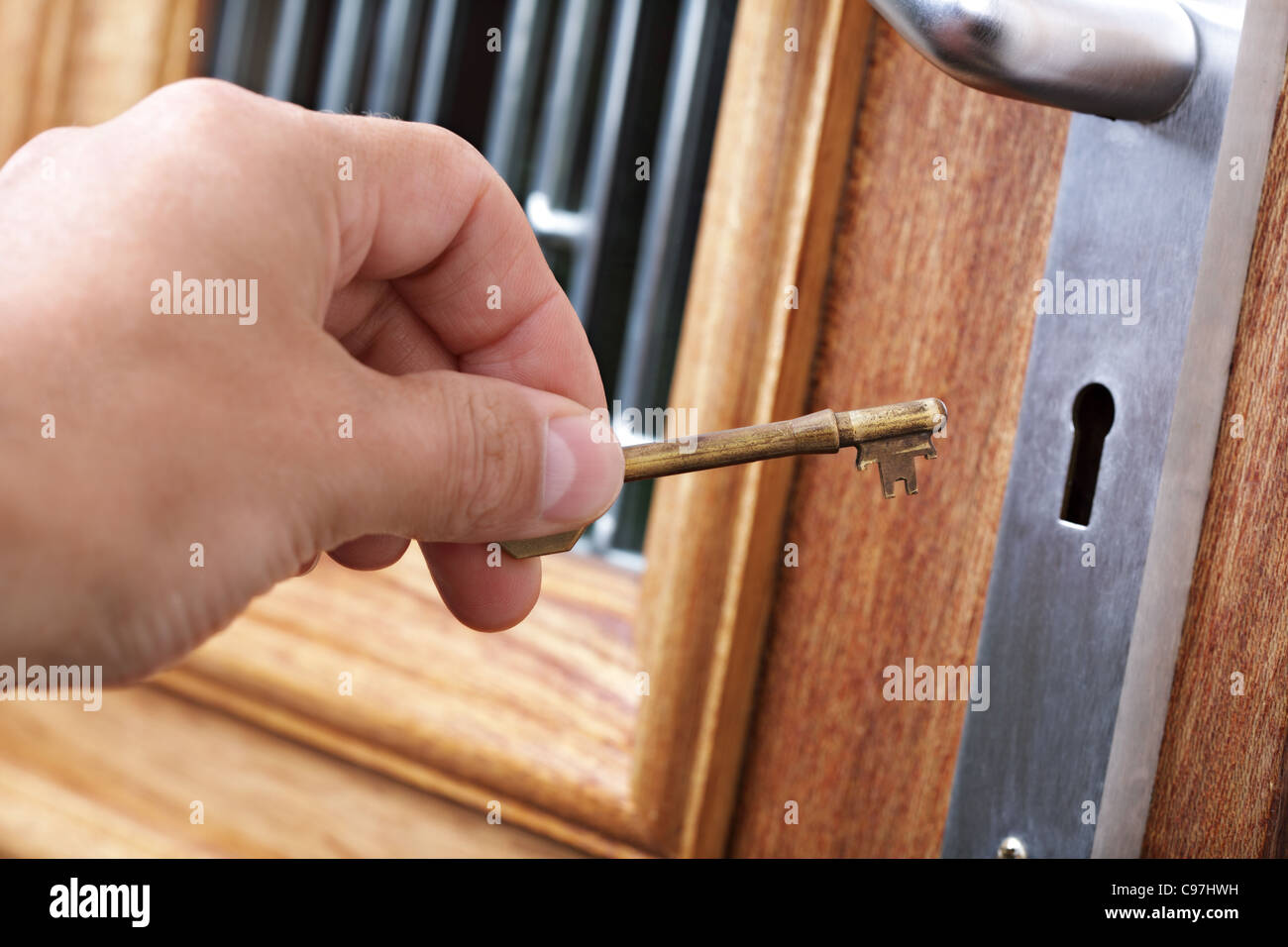 Unlocking a door with a house key Stock Photo