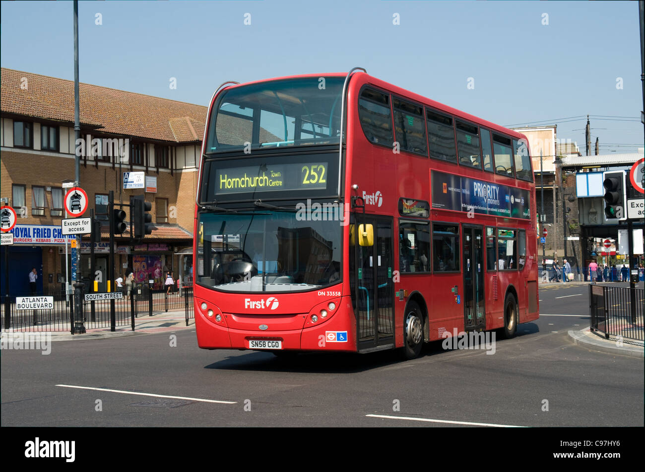 An Alexander Dennis double deck bus operated by the First Group has just passed Romford station. Stock Photo