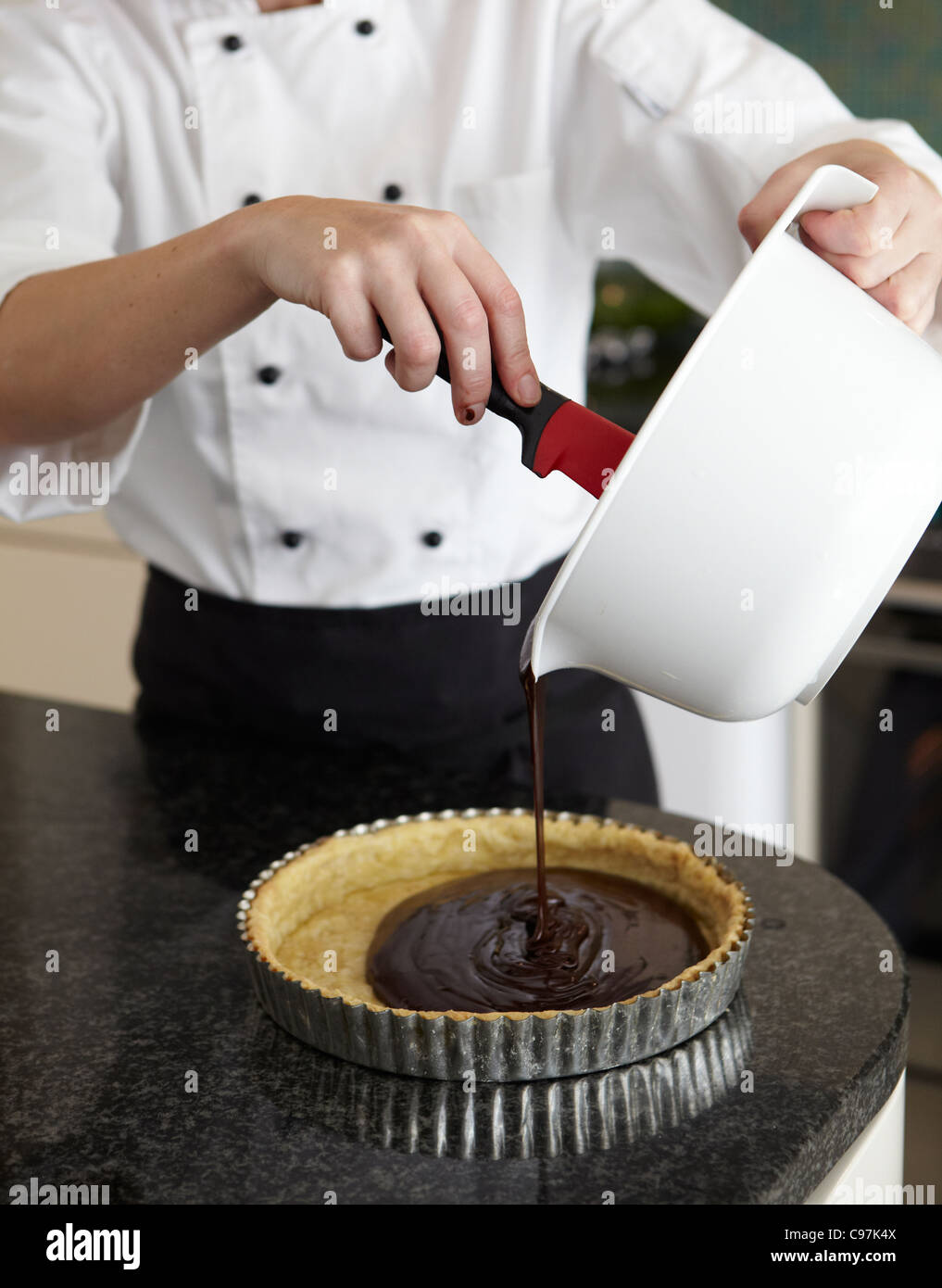 Chef making a chocolate torte. Stock Photo