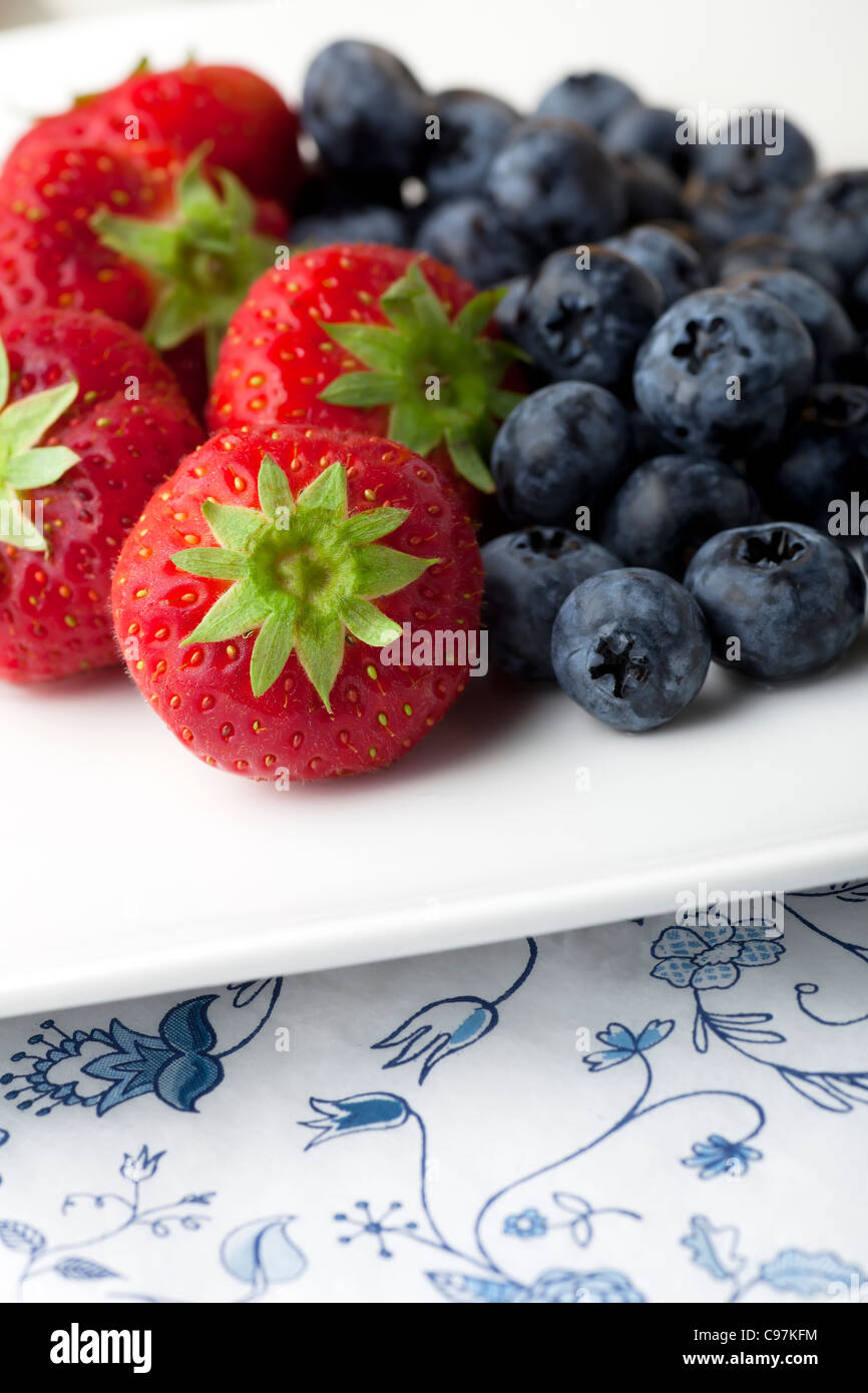 Fresh strawberries and blueberries on white plate Stock Photo - Alamy