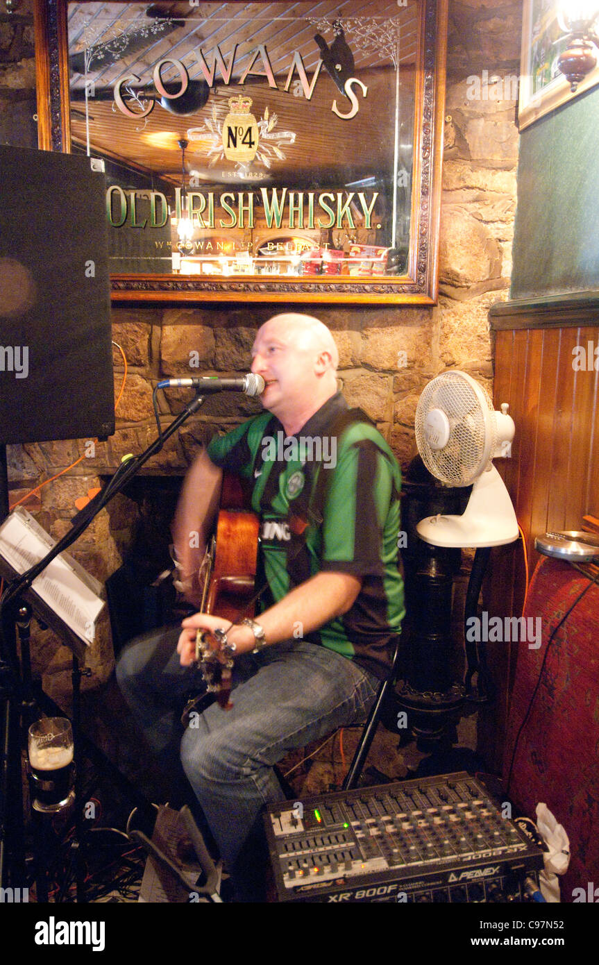 Ireland. Man playing guitar and irish music in local pub. Stock Photo