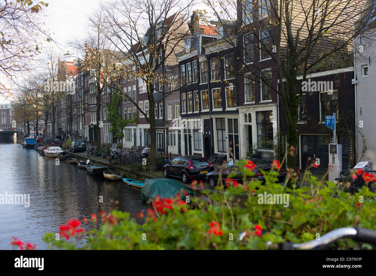Amsterdam canal side scene lined with typical, period Dutch architectural styled property Stock