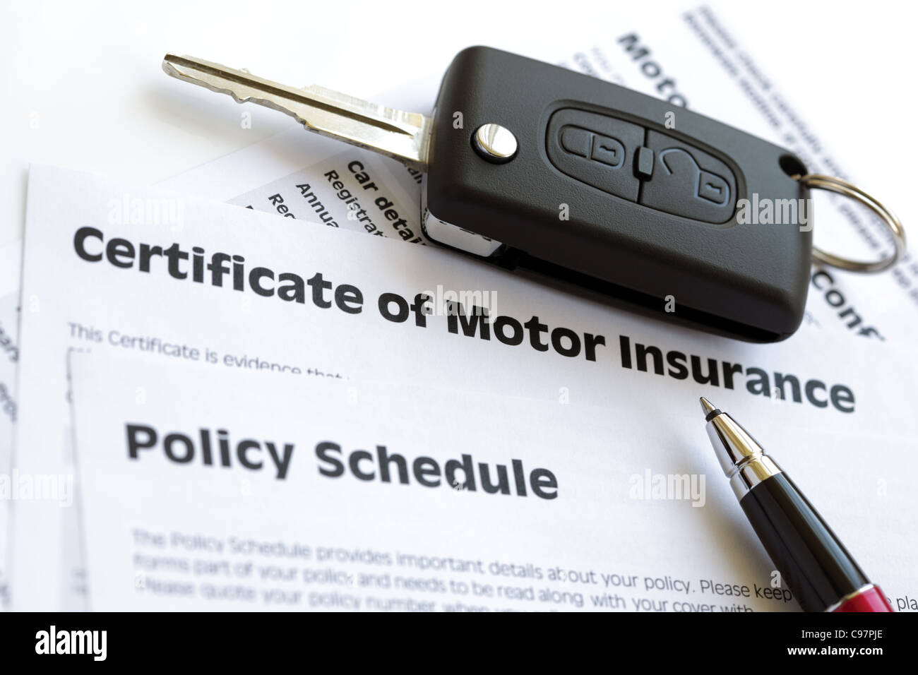 Motor insurance certificate with car key Stock Photo