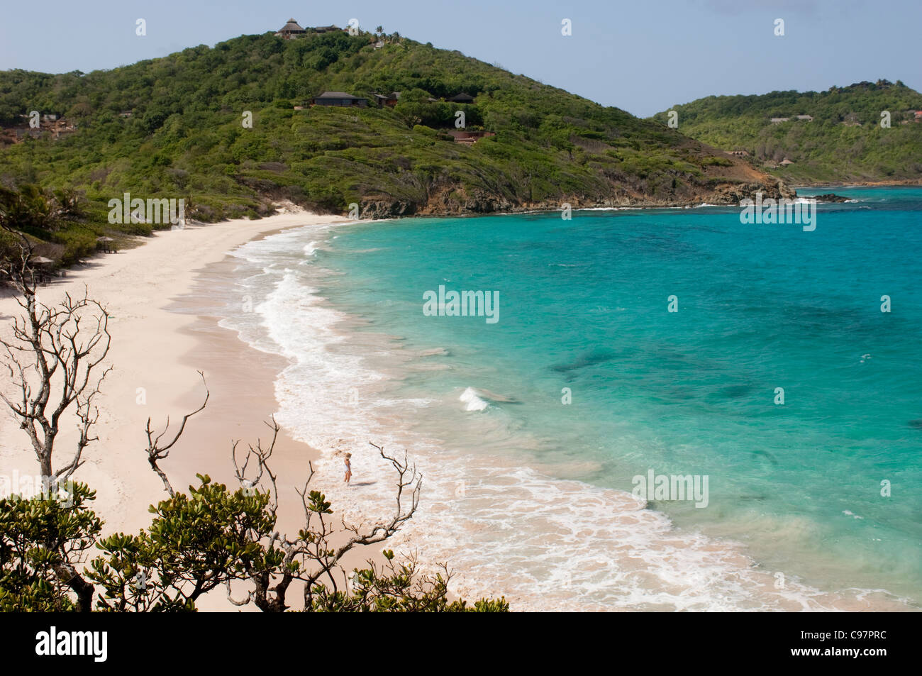 Caribbean Islands. St. Vincent and the Grenadines. Mustique. Solitary woman on deserted Macaroni