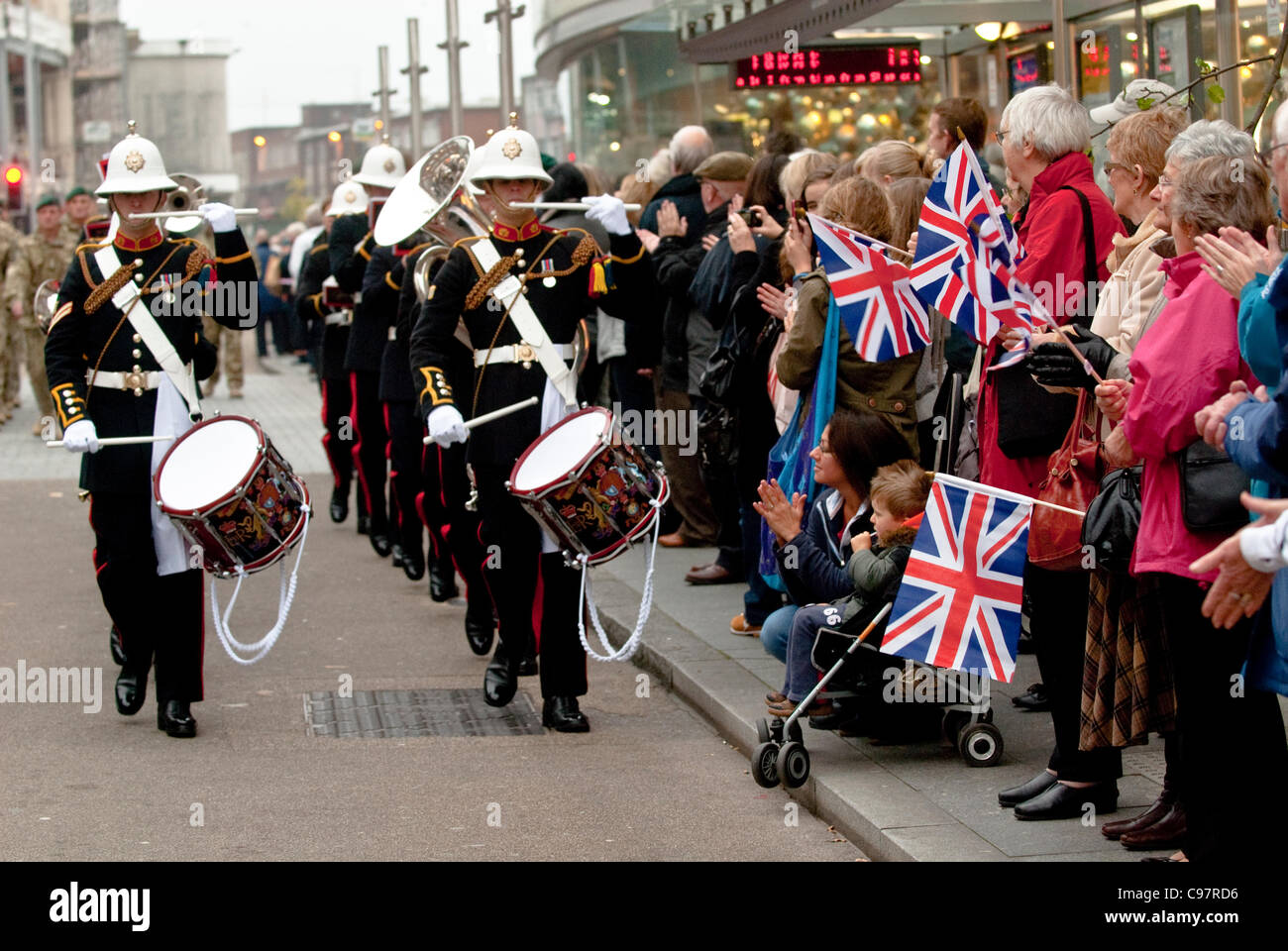 The crowds cheer & wave their Union Flags at the maching band approches ...